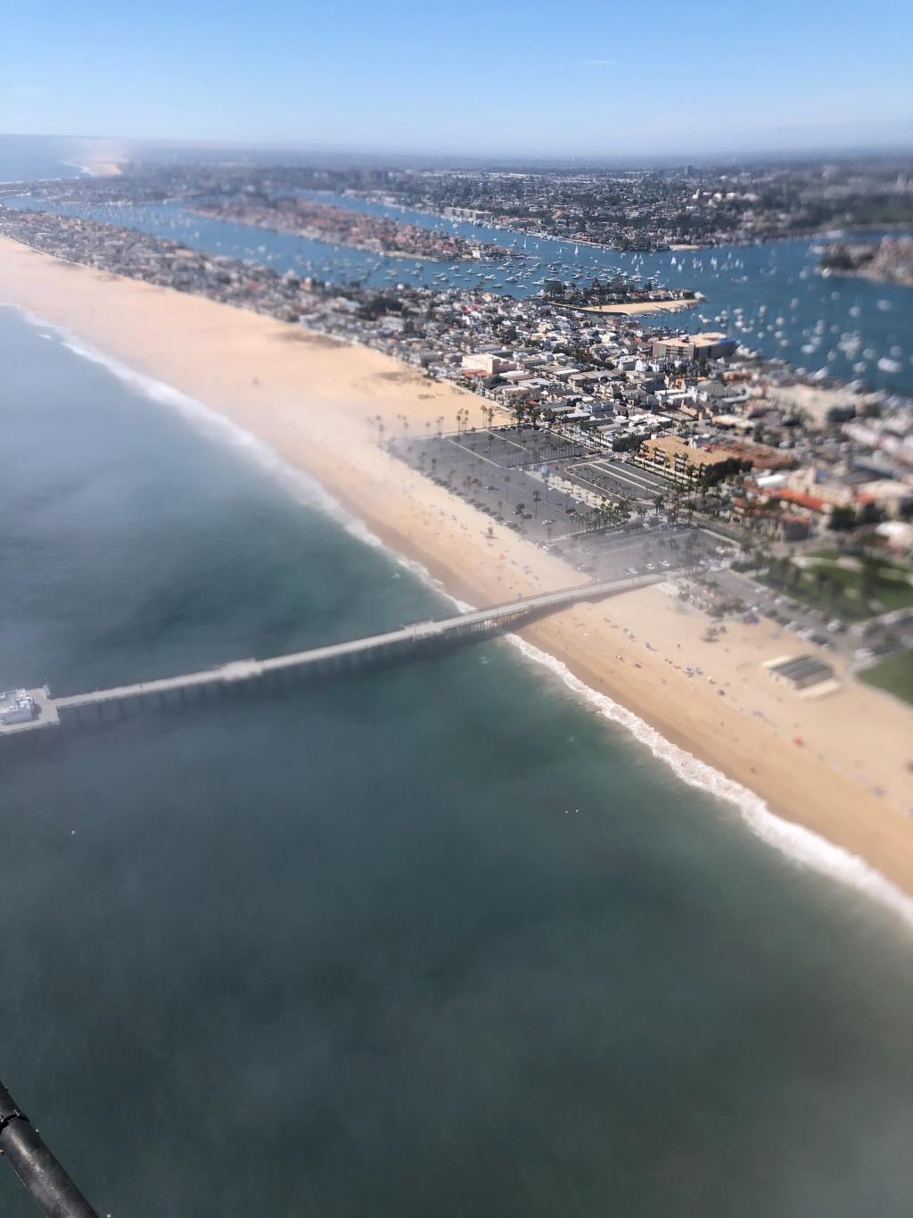 from a helicopter overlooking the Balboa Pier and parking lot between 2 and 230 saturday